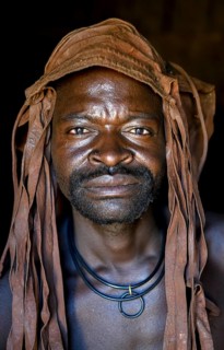 Himba man in his hut, Ohandungu, Kunene region, Kaokoveld, Namibia, Africa