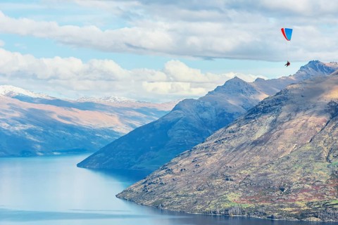 Paragliding over the Remarkables mountain range, Queenstown, South Island, New Zealand, Oceania