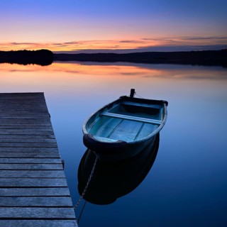 Quiet lake with jetty and rowing boat after sunset at dusk, Großer Lychensee, Lychen, Brandenburg,