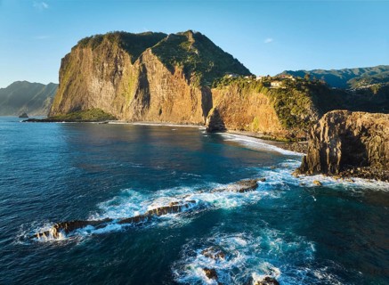 Aerial view of Madeira cliffs coastline landscape on sunrise, Guindaste viewpoint, Madeira island,