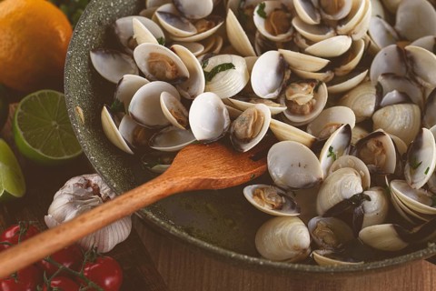 Cooking, vongole clams, in a pan with spices and white wine, top view, no people
