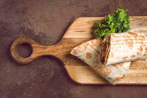 Cut shawarma, 2 pieces, on a cutting board, close-up