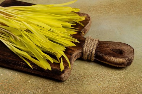 A microgrown corn, a bouquet on a cutting wooden board, no people