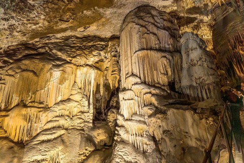 Illuminating the magnificent stalactites and stalagmites within postojna cave, showcasing nature's