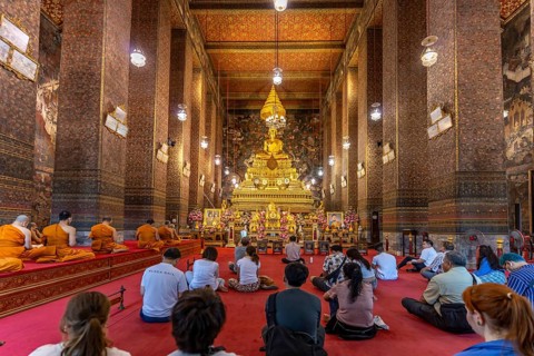 Prayer with monks in the Buddhist Phra Ubosoth, Wat Pho temple complex in Bangkok, Thailand, Asia