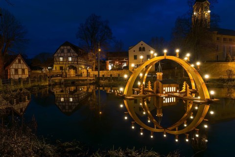 Floating double candle arch from the Ore Mountains with model of the church on the village pond,