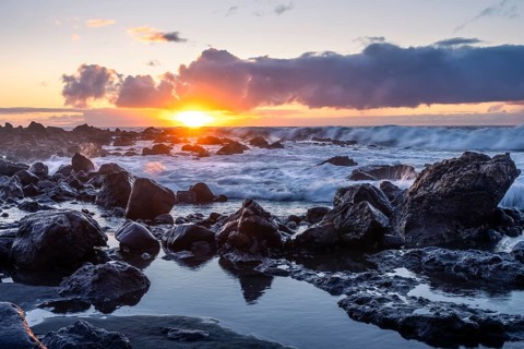 Rocks on the beach of Playa del Inglés. Sunset. Long exposure. Sea and waves. Valle Gran Rey, La