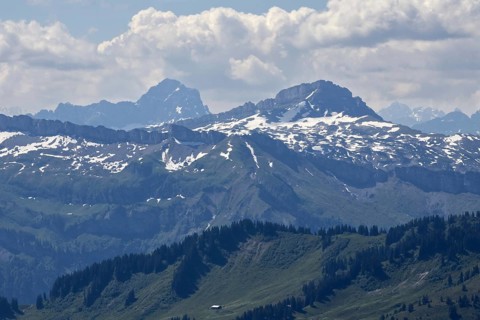 View from Hochgrat of imposing snow-covered Alps with clouds and blue sky, Oberstaufen, Bavaria,