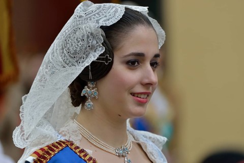 Fallas festival, woman in a traditional costume during the parade in the Plaza de la Virgen de los