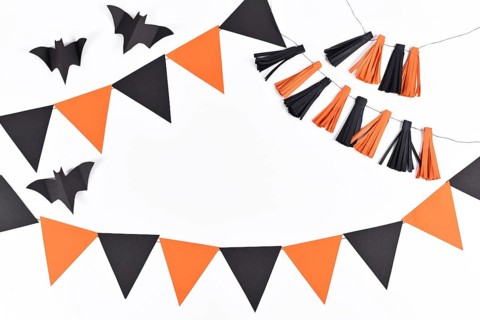 Halloween background with garlands and paper bats in traditional colors orange and black on white
