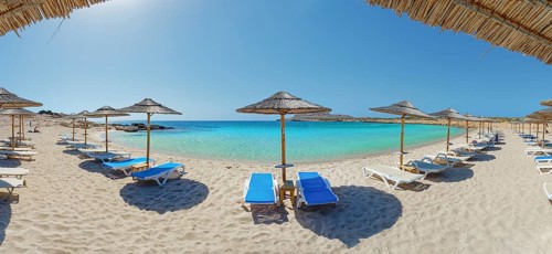 Diakoftis sandy beach with sun loungers and parasols, surrounded by clear, turquoise-coloured sea,