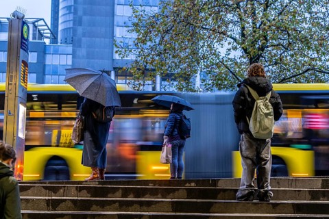 Autumn, rainy weather, bus stop at the central station, passengers waiting for the bus, Essen,