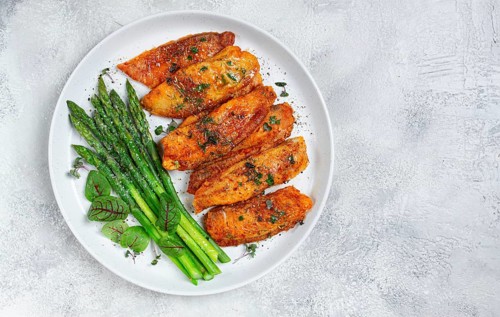 Fried fish fillet, tilapia with asparagus, homemade, no people