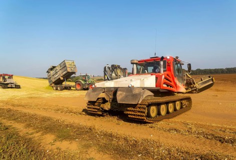 Piston Bully tracked bulldozer vehicles building silage clamp of sweetcorn maize in field stored