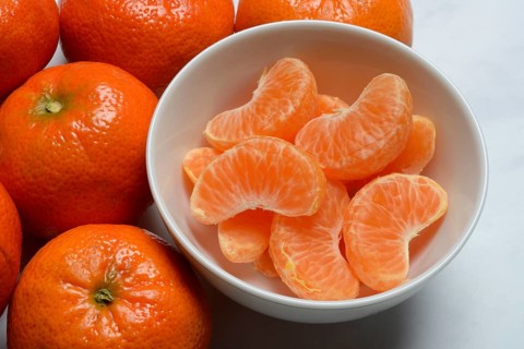Clementines and clementine pieces in peel, clementine