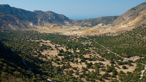 Panoramic view of a green valley surrounded by high mountains and blue sky, volcanism, volcanic