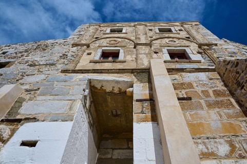 Old historic wall with windows and decorated stone in the sunlight, Querini Castle, Chora,