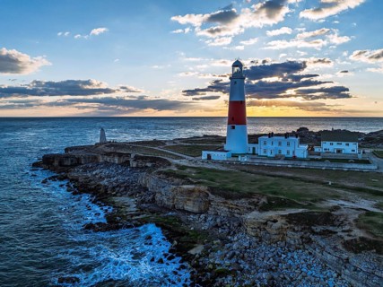 Sunset over Portland Bill Lighthouse from a drone, Portland Bill, Isle of Portland, Dorset,