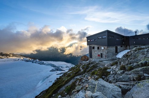 Mountain hut Refuge Albert 1er, high alpine mountain landscape at sunset, Glacier du Tour,