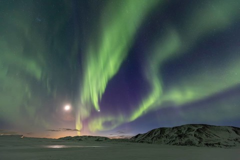 Green northern lights, aurora borealis over snowy mountains, volcanic, winter, moon, Laugarvatn,
