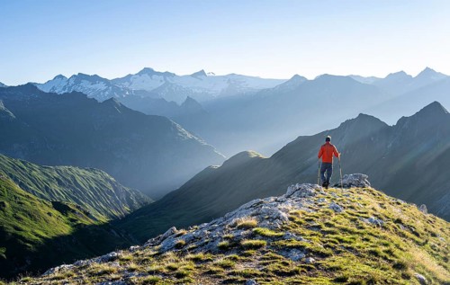 Hiker enjoying the mountain panorama in the morning, Venediger group, behind Dreiherrenkopf,