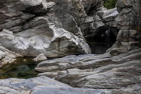Rocks, granite rock formations in the Maggia River near Ponte Brolla, in the Maggia Valley, Valle