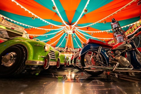 Carousel with reflective lights and colourful vehicles, Christmas market Ludwigsburg, Germany,