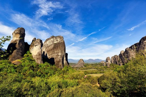 Hermitages between high rocks, monasteries on sandstone formations, Meteora, blue sky, spring
