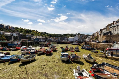 Fishing boats in tidal harbour, low tide, Mevagissey, St Austell, Cornwall, England, Great Britain