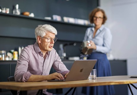 Symbolic photo on the subject of division of labour for couples in the household. A man sits in a