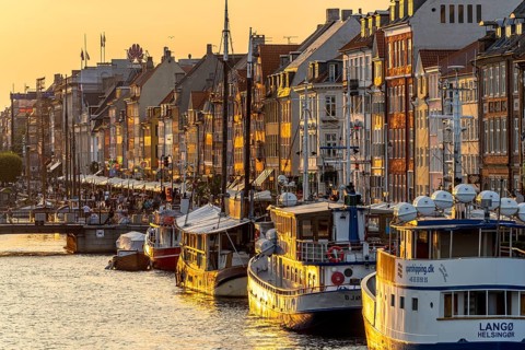 Colourful houses, restaurants and historic ships on the Nyhavn canal and harbour, Copenhagen,