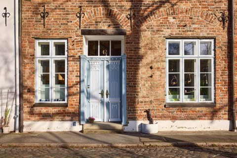 Historic brick house, entrance door, window, wall anchor, street An der Obertrave, Old Town,