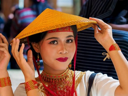 Toraja woman in traditional colourful clothing with rice straw hat, portrait, Tana Toraja,
