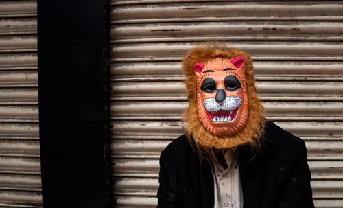 A person wears a mask to play Holi, the Hindu spring festival of colours, on March 14, 2025 in