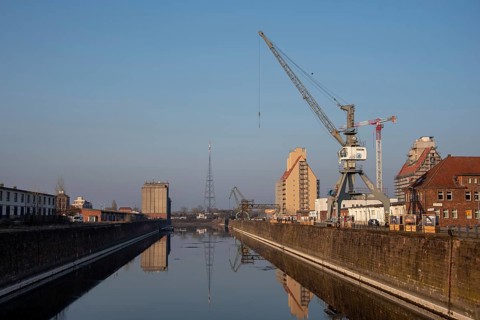 Quiet harbour view with cranes and water in the morning light, Science Harbour, Magdeburg,