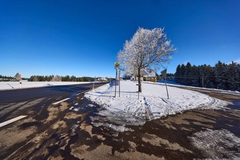 Winter landscape, federal road B500, bus stop, snow-covered tree, deep blue cloudless sky,