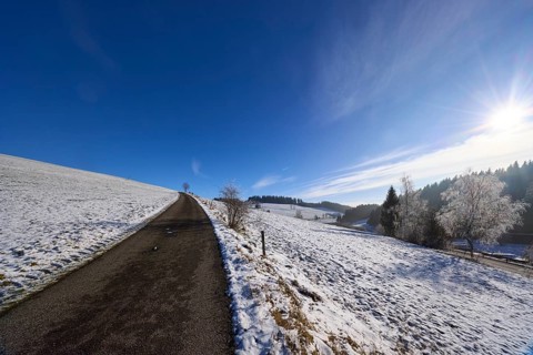 Hilly winter landscape, snow, road, deep blue sky with cirrostratus clouds, Titisee-Neustadt, Black