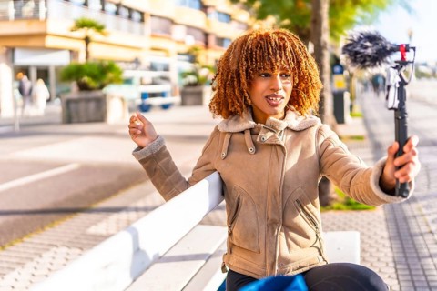 Millennial content creator latin young woman vlogging online in the city