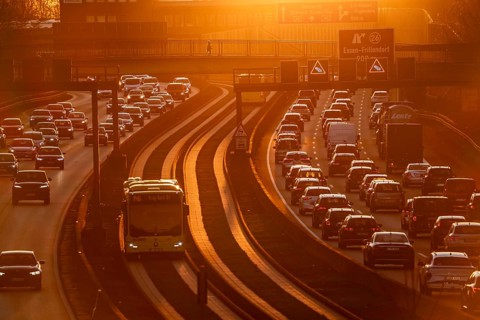Motorway A40, dense, slow-moving traffic jam, evening traffic at the Essen-Kray junction, low sun,