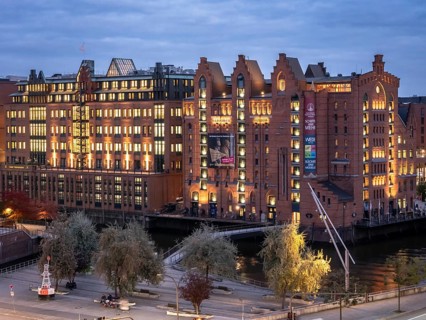 Aerial view of the International Maritime Museum Hamburg surrounded by trees during the blue hour