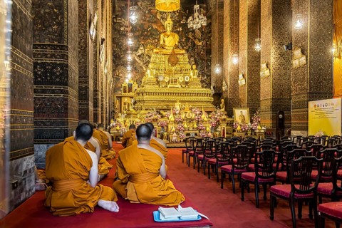 Wat Pho temple in Bangkok near the Grand Palace. Buddhist monks during a religious ceremony.