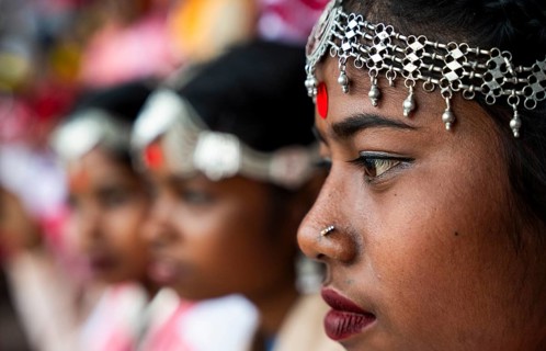 Girls from tea tribe community wait to perform traditional Jhumur dance, on the eve of 'Jhumoir
