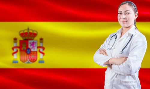 Female doctor on Spain flag. Doctor with crossed arms on Spain flag. Spain Health and Care concept
