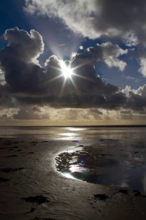 Sunburst through the clouds over the beach, South Shore, Blackpool, England, United Kingdom, Europe