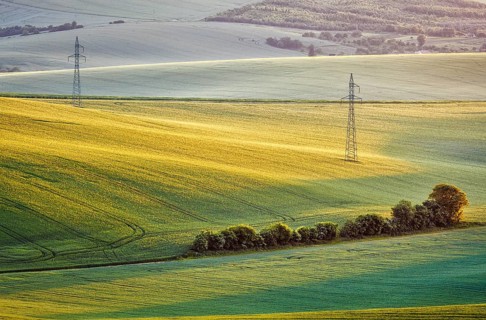 Moravian summer rolling landcsape with two power line tower. Moravia, Czech Republic, Europe