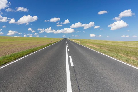 Straight country road, B173 between Dresden and Freiberg, without cars, blue sky with fair weather