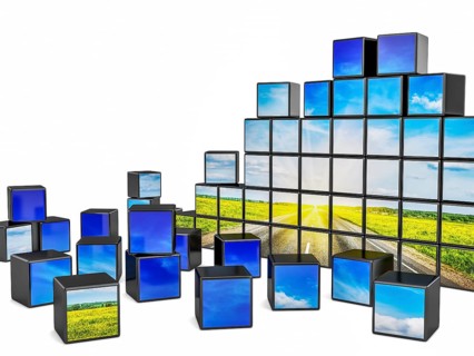 Travel concept background, cubes with beautiful landscape road in blooming spring meadow on sunset