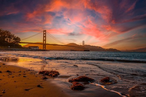 Gorgeous orange sunset with pink clouds over the Golden Gate in San Francisco, California. United