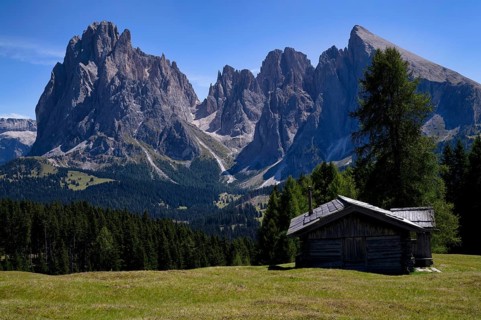 Alpine hut in front of the Langkofel and Plattkofel mountains, Alpe di Siusi, South Tyrol, Italy,