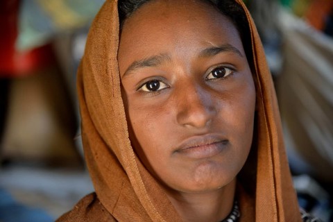 Young girl from a nomadic tribe, wearing headgear, portrait, Bayuda Desert, in Karima, Nubia,